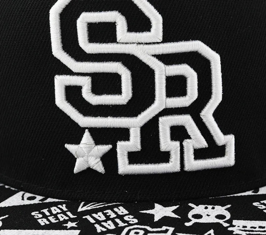 Black and white adjustable cotton baseball cap with embroidered lettering and dome crown.