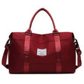Travel duffel bag in black with zipper closure and soft handle, 20-35L capacity nylon gym tote