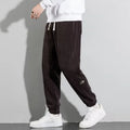 Men's loose straight drapey sweatpants in dark gray with drawstring waist and cotton blend fabric