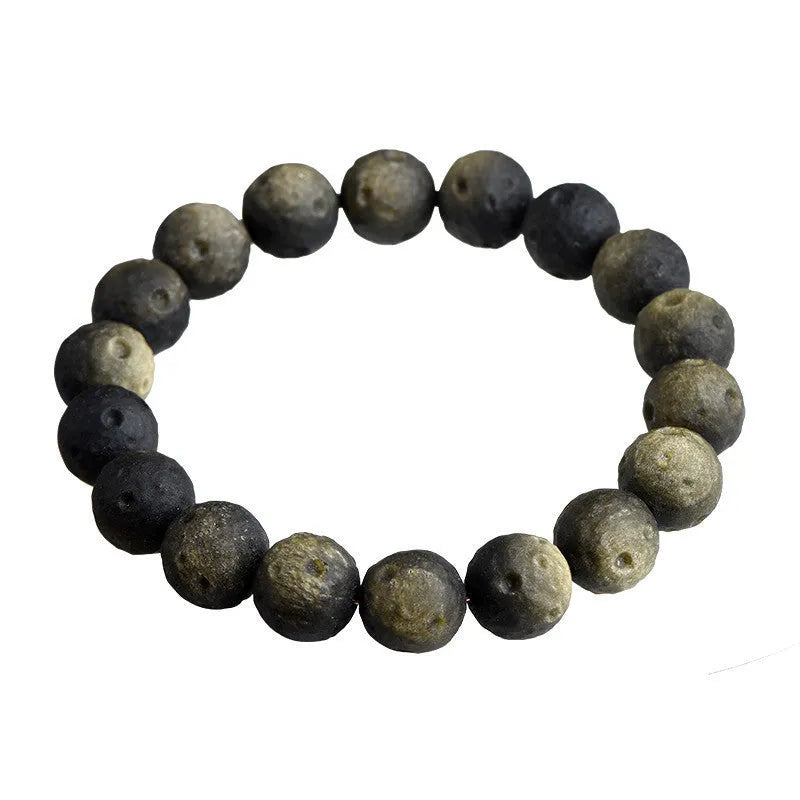 Natural obsidian crater ball bracelet with textured beads in silver stone meteorite finish.