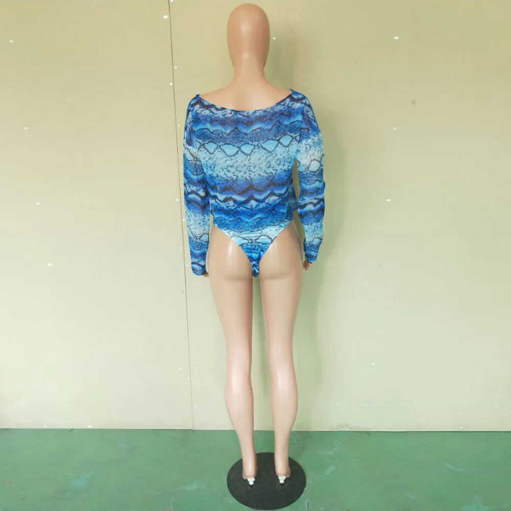 Women's purple snakeskin print bikini set with long sleeves and split shorts laid flat