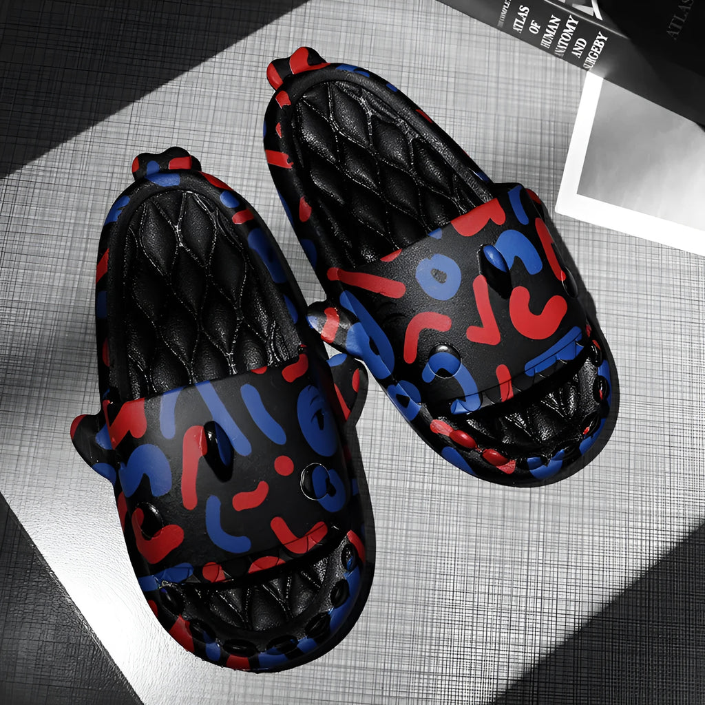 Pair of open-toe EVA slippers with a shark couple design on the footbed.
