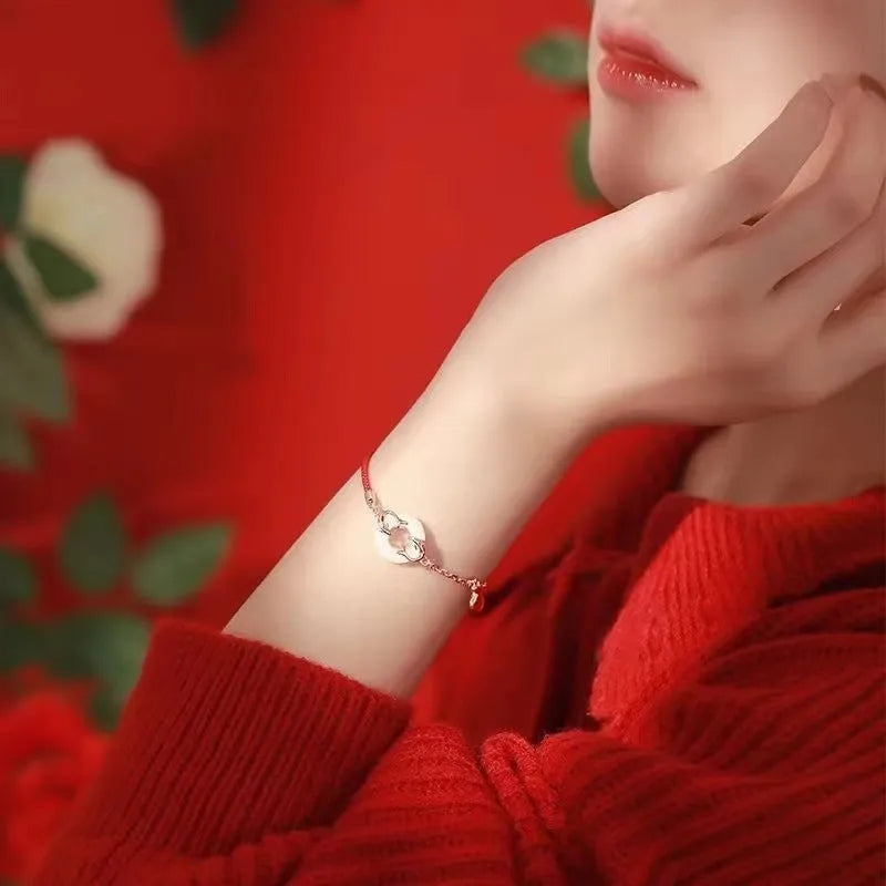 Festive koi bracelet with peace buckle fastening, adjustable red rope and fish tail decorative elements