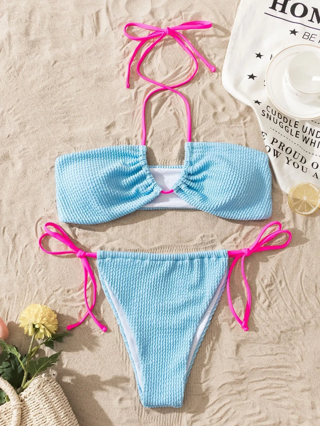 Solid colour women's two-piece swimsuit with halter neck and lace-up back detail