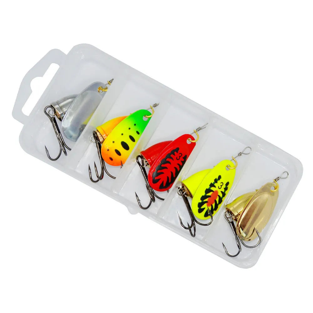R composite rotating sequin copper bell fishing lure in gold colour variant on a blue background