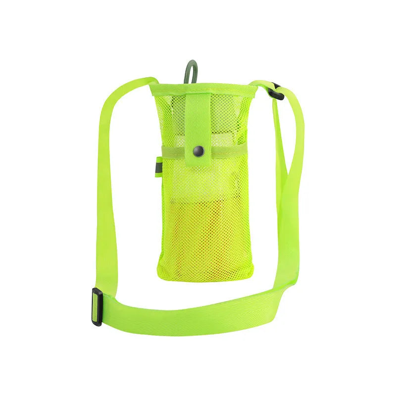 Nylon water bottle holder in black with adjustable shoulder strap on a beach setting