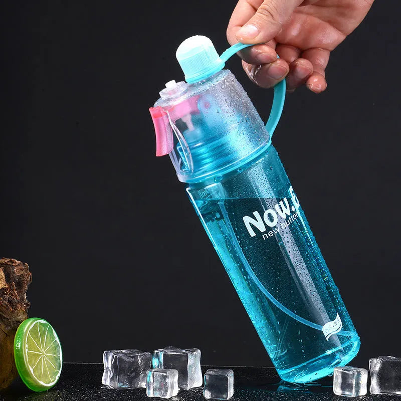 Green portable outdoor sports mist spray cup with handle, transparent scale, and spray mouth.