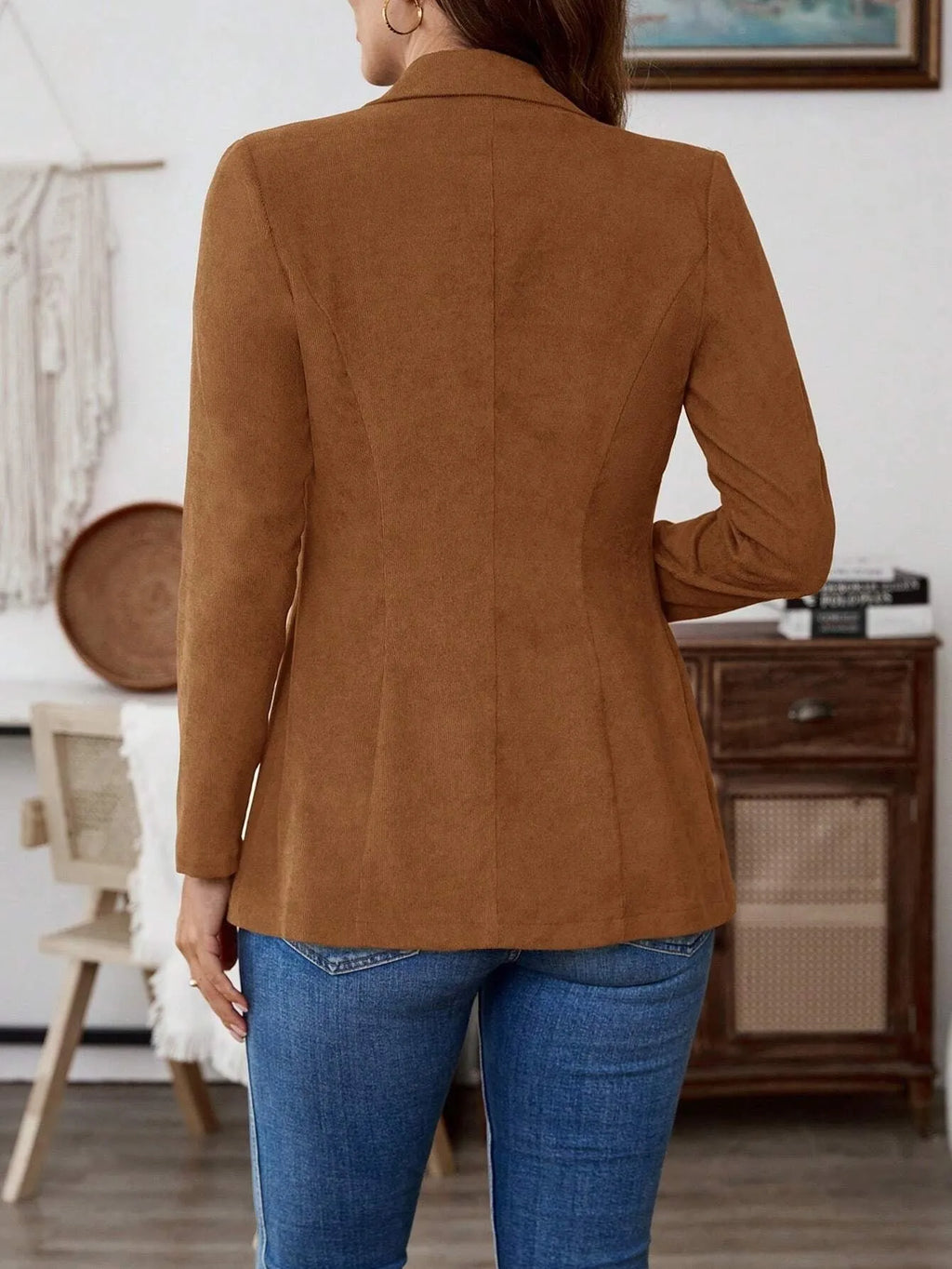 Brown single-breasted leisure suit coat with lapel collar and long sleeves laid flat.