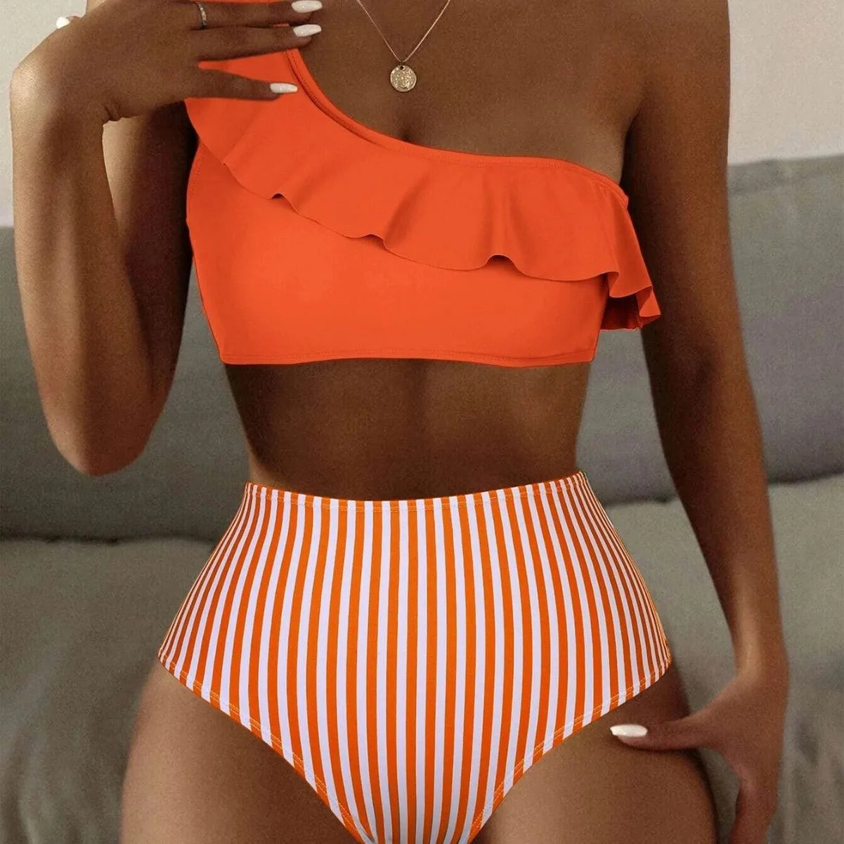 Women's striped and solid colour bikini swimsuit set on a white background.