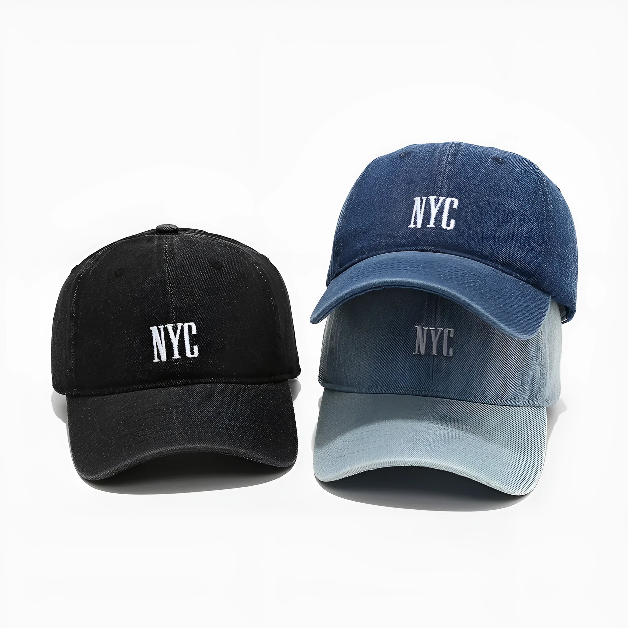 Light blue denim peaked cap with embroidered letters on a dome crown, showing adjustable strap.