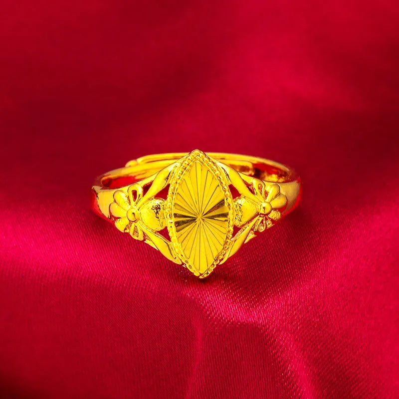 Gold coloured brass ring with open diamond flower design and geometric textured shape