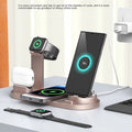 Black three-in-one wireless charging desk stand holding a phone, with integrated headphone bracket and fixed charging docks.