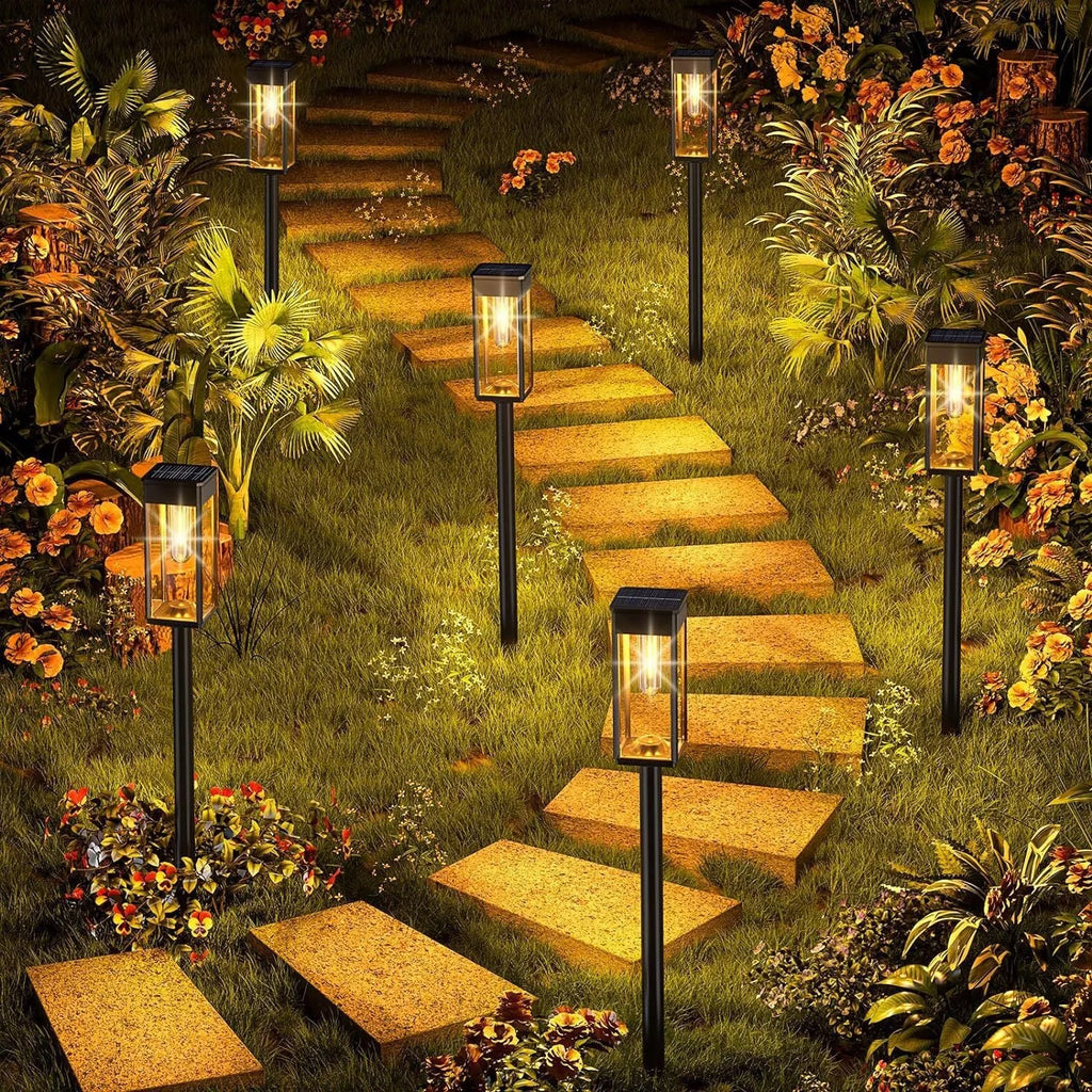Round tungsten wire solar lawn lamp on grass in a garden courtyard emitting warm light