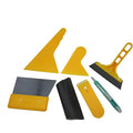 Seven-piece car film tool set including scrapers, knives, and a pressing block on a work surface.
