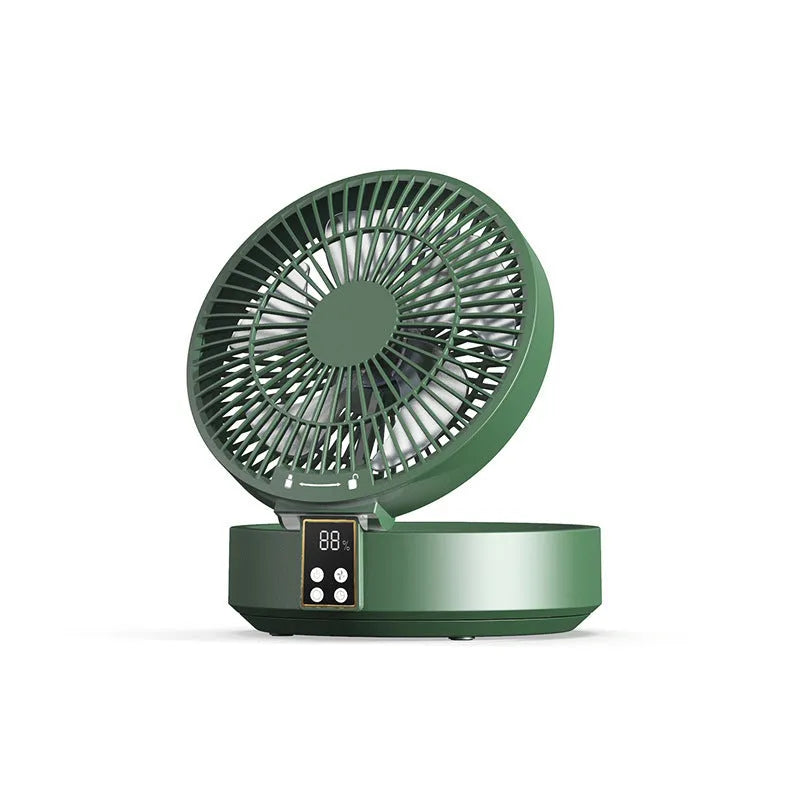 White rechargeable USB ceiling fan with remote control folded on a desk next to its charging cable.