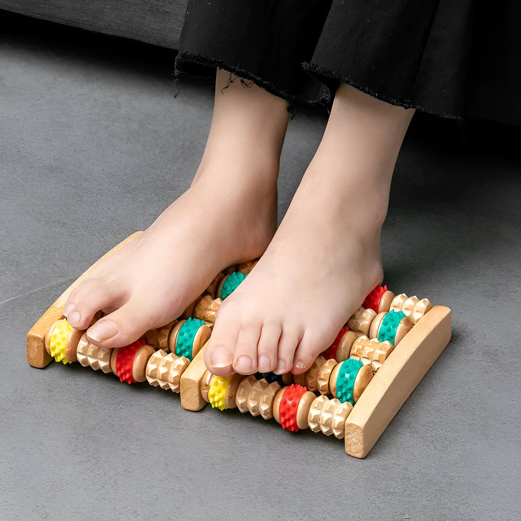 Wooden six-row roller foot massager for acupoint hand massage on a flat surface