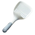 White plastic cat litter scoop sitting in its matching storage base.