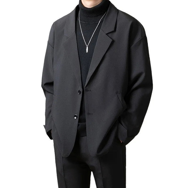 Man wearing a loose-fit apricot coloured casual suit jacket in a light business style.