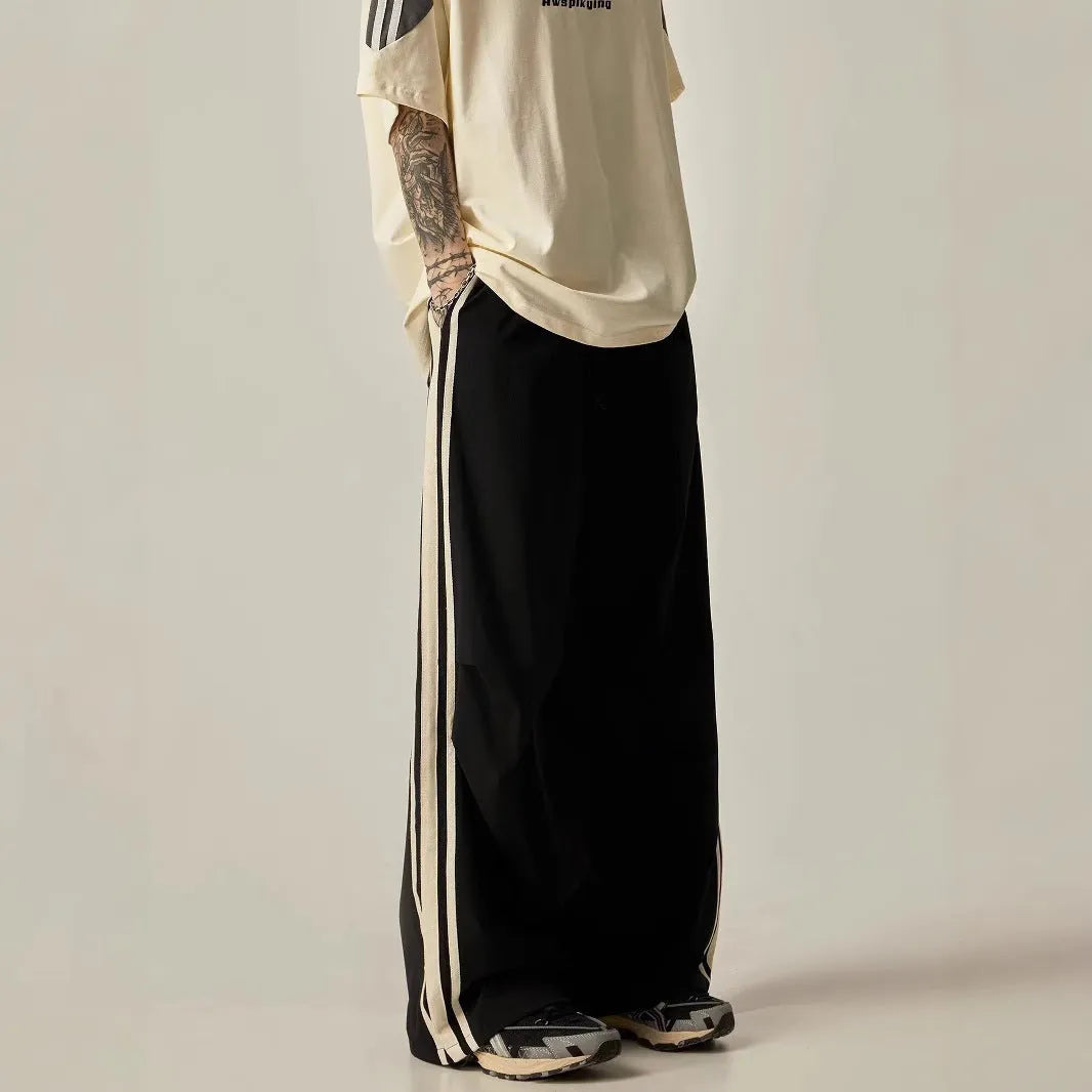 Men's black high-waist wide-leg climbing trousers with straight leg on a plain background.