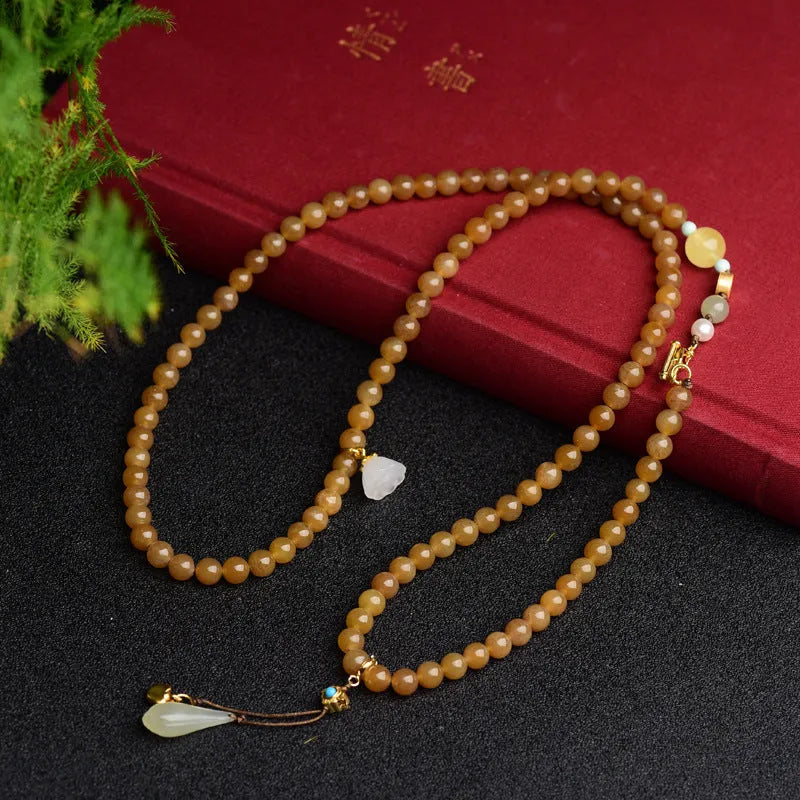 Women's natural bracelet with green pine beads, jade leaves, and beeswax accents