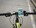Silicone bicycle phone holder mounted on handlebars showing 3 adjustment holes and secure locking mechanism