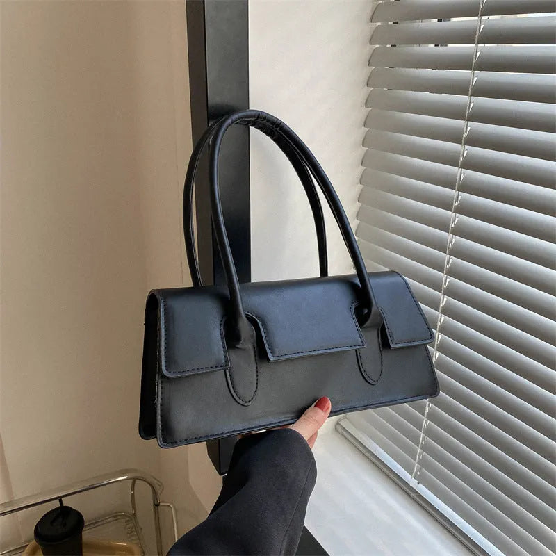 Women's square shoulder bag in black with stitching detail and single shoulder strap