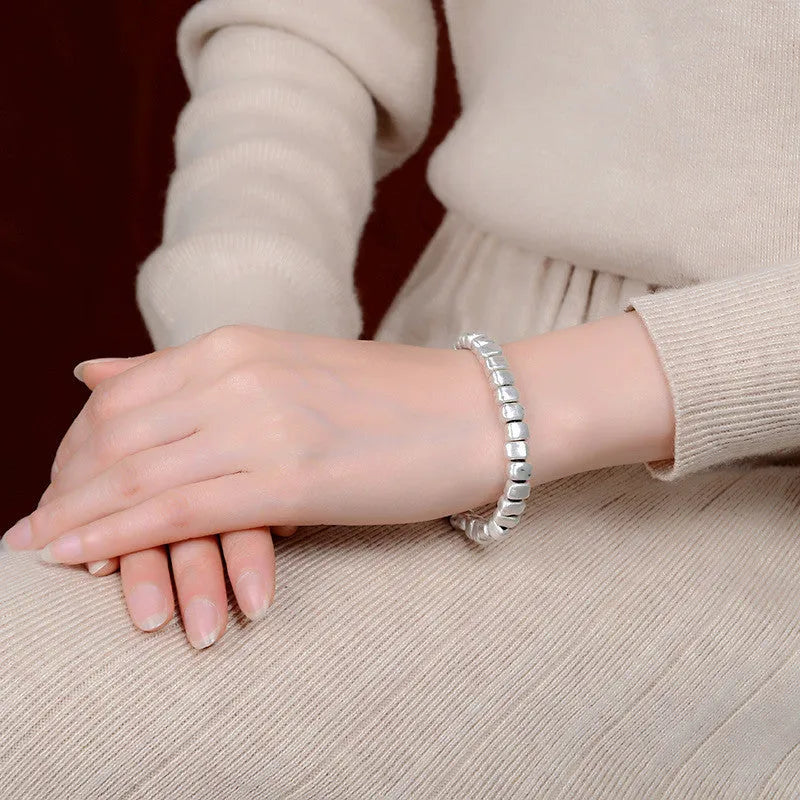 Women's handmade silver bracelet with wooden irregular square design on elasticated band