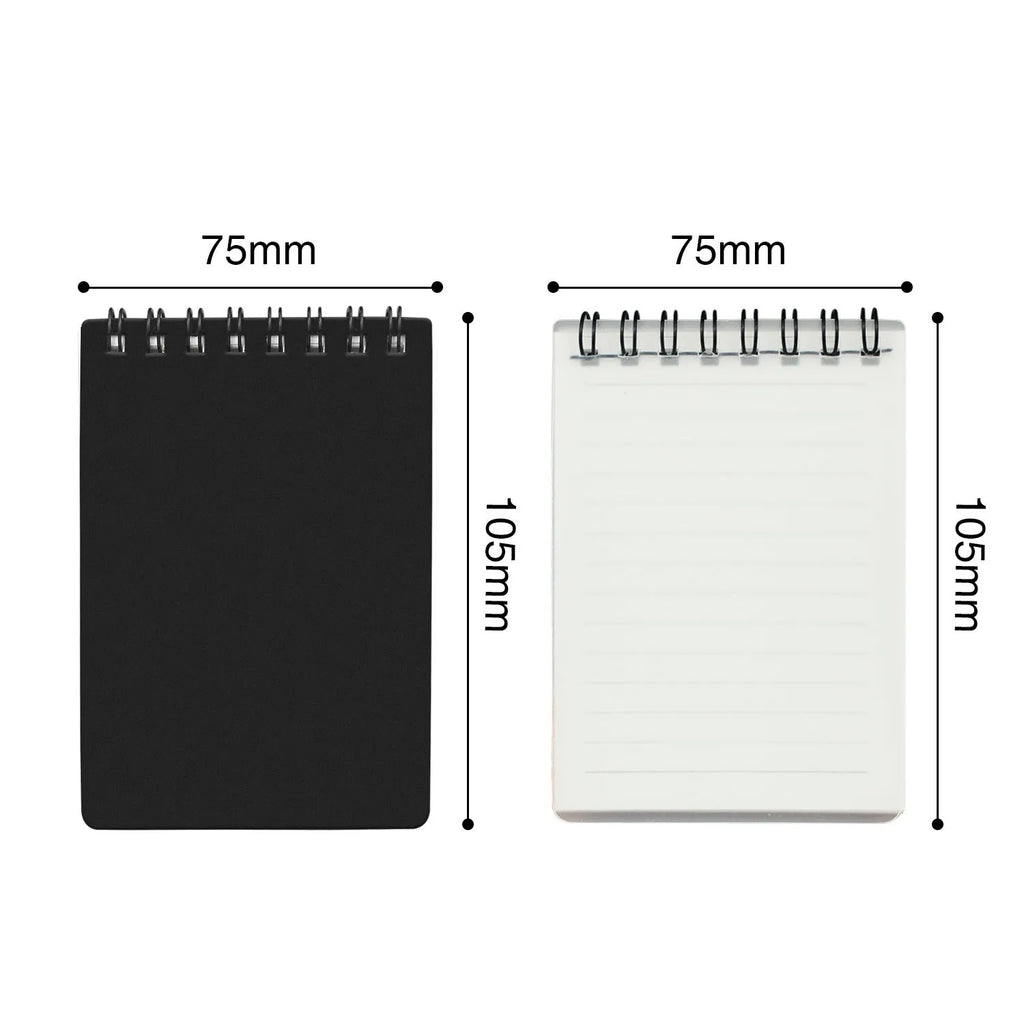 Spiral-bound black business notepad with pen and cleaning rag on a desk.