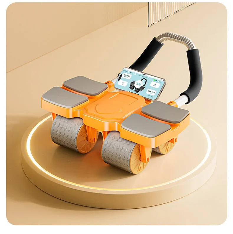 A black abdominal exercise wheel with four wheels and an automatic rebound mechanism on a floor.