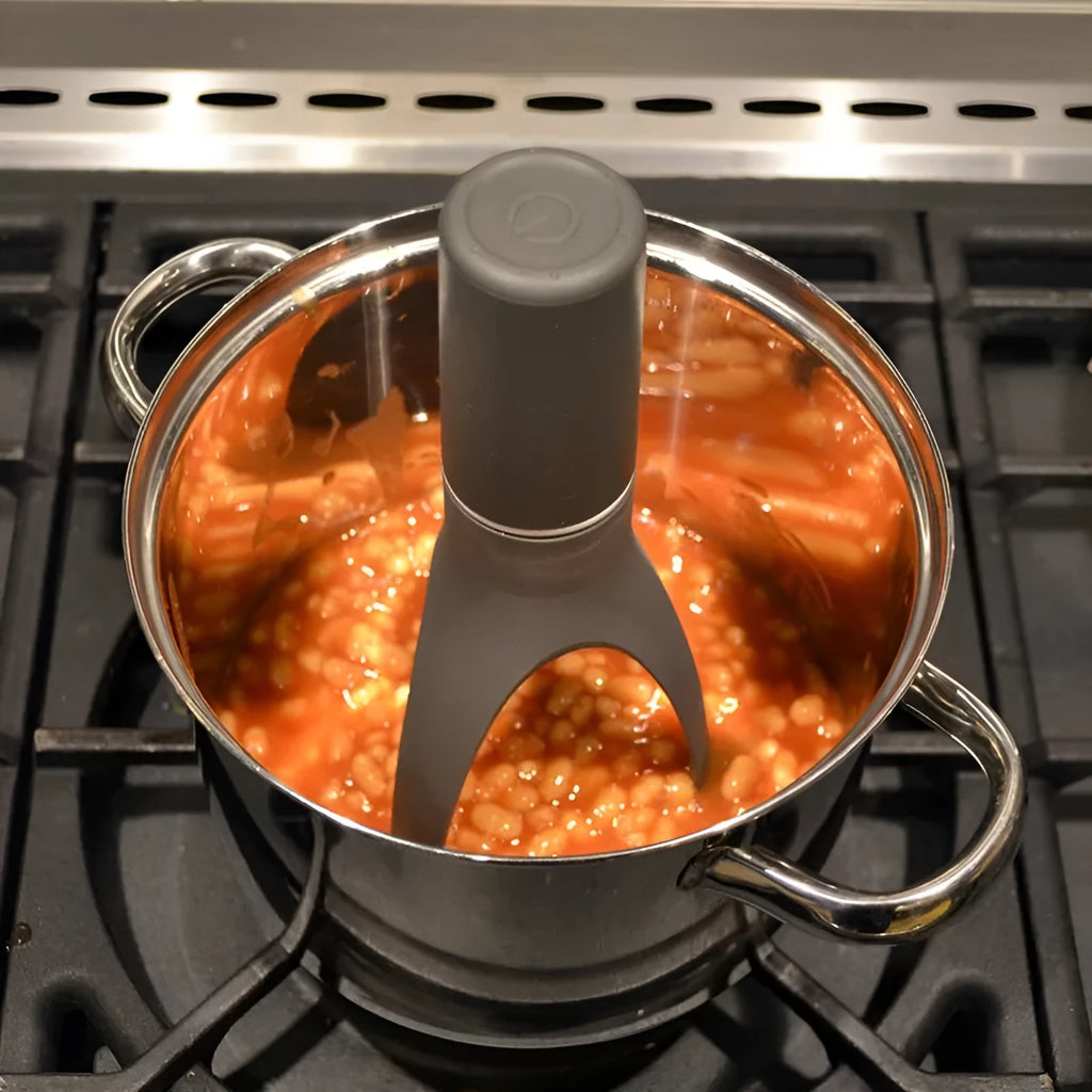 Green Uutensil Stirr automatic handheld mixer for pots, showing its compact size.