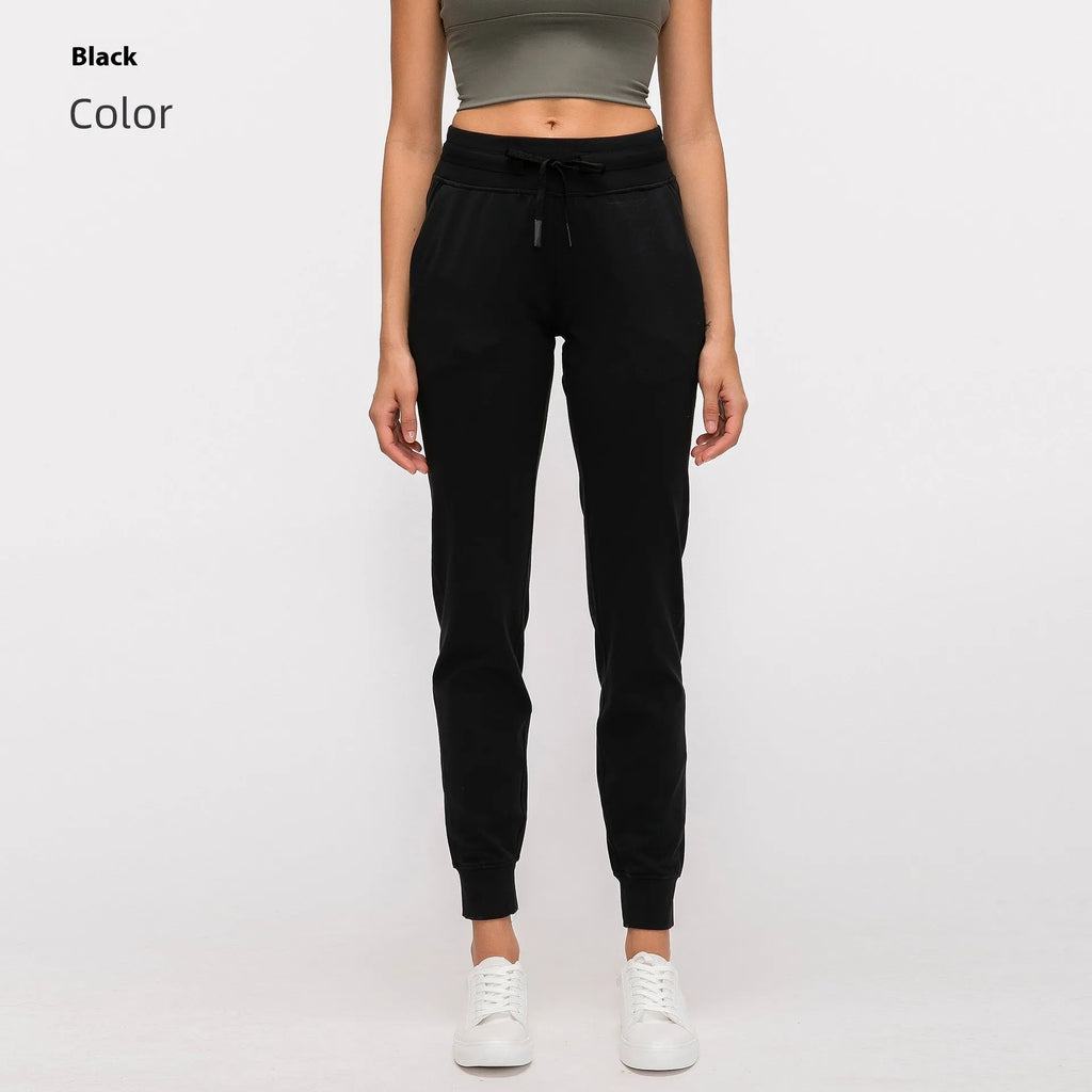Women's high-waist yoga pants in a cotton blend with a drawstring waist, shown in Belgian Blue colour.