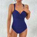 Solid colour one-piece swimsuit for women in black, blue, dark blue, or red on a hanger