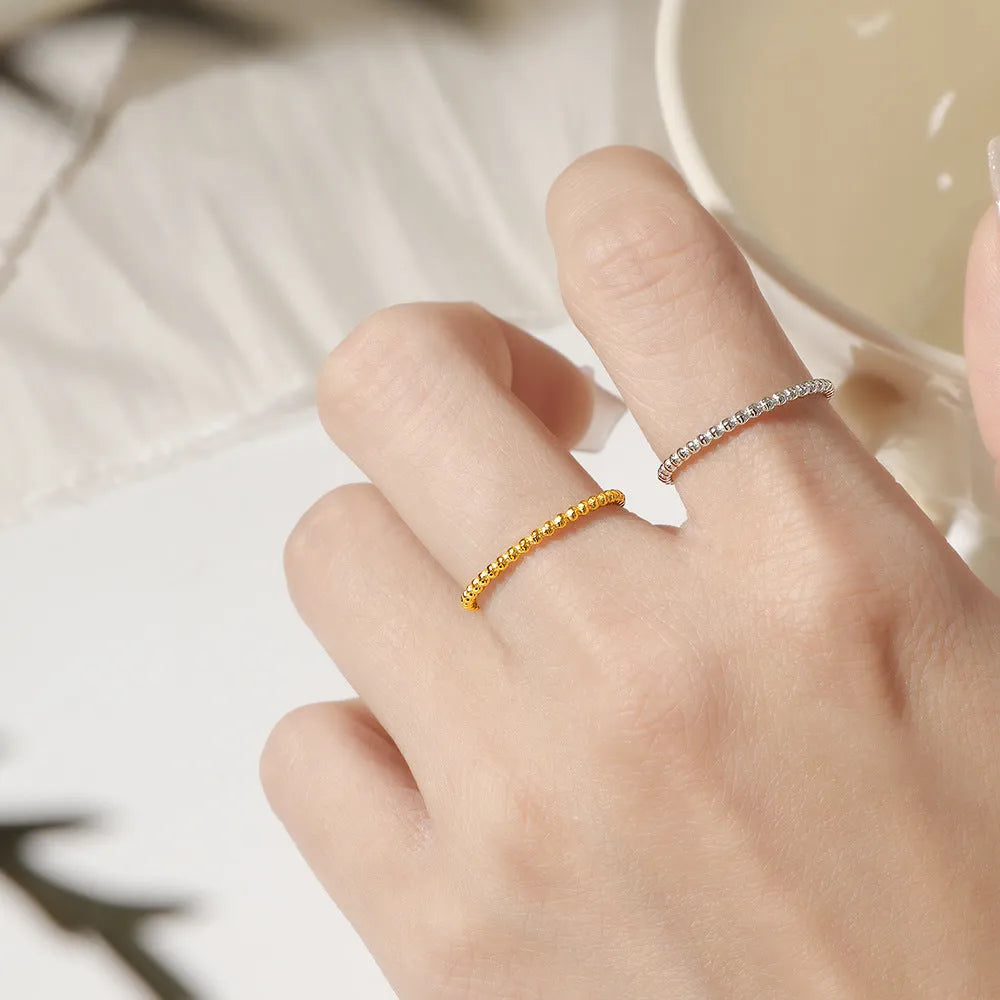 Titanium steel plain circle ring in gold finish on a neutral background