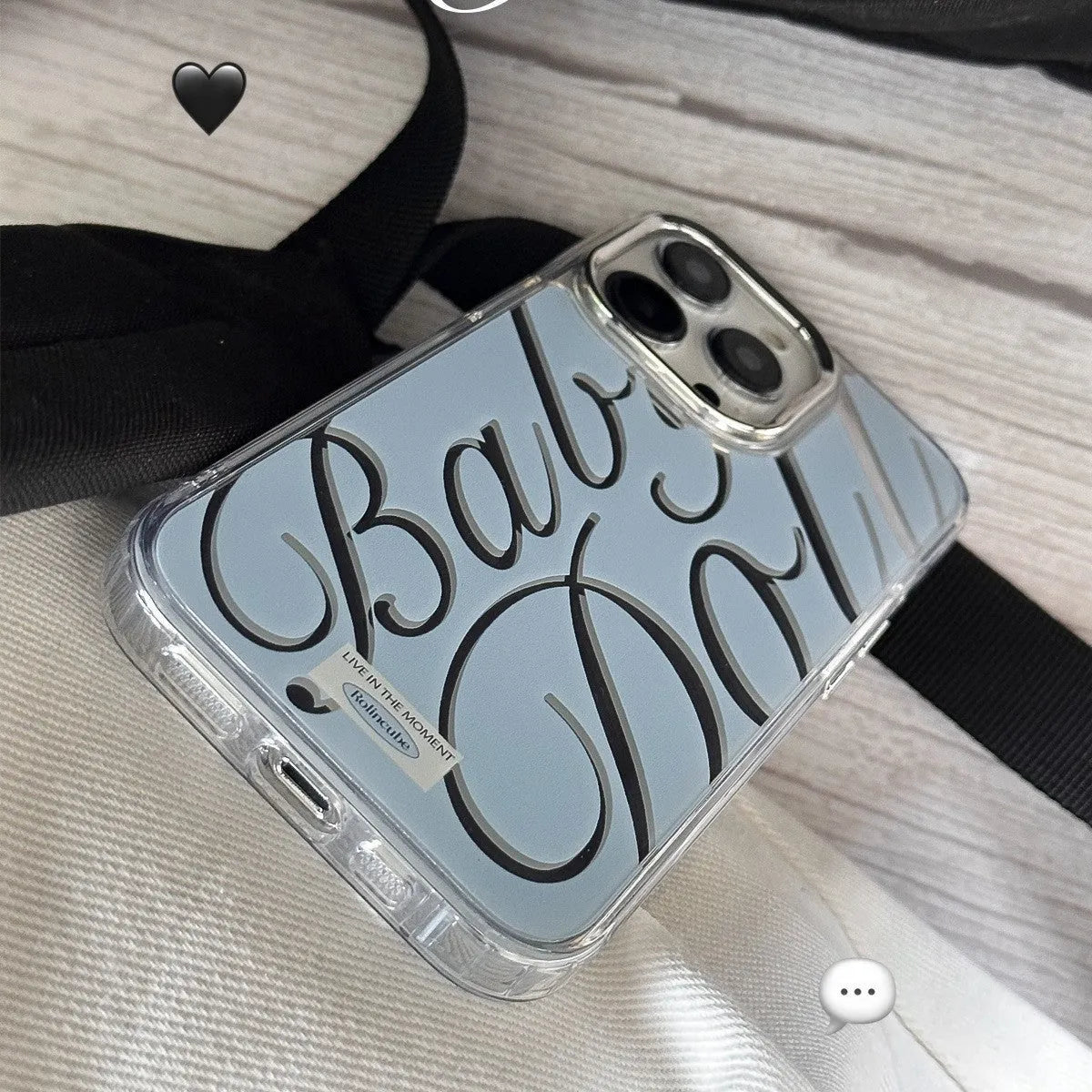 Transparent blue iPhone case with mirror surface and white JMKJ letters showing front and back views