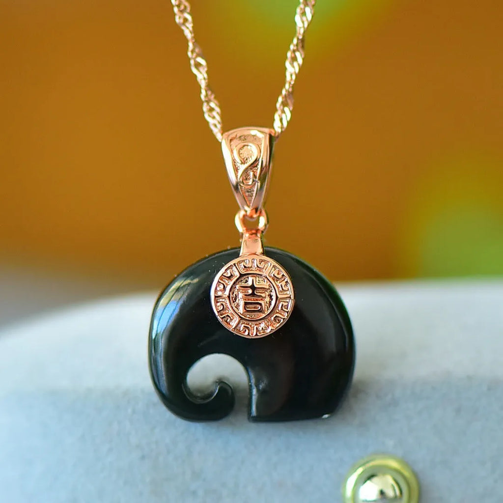 Flat Hetian jade pendant necklace with copper inlay on a gray background.