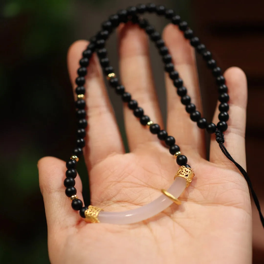 Natural frosted black agate and white chalcedony necklace with silver pendant on ball bead chain.