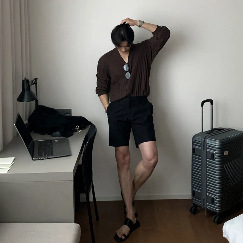 Man wearing loose straight-leg casual shorts in solid khaki colour