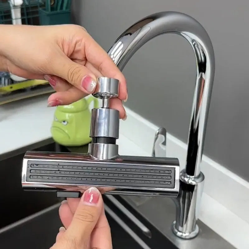 Brushed nickel kitchen faucet connector with pull-down sprayer, showing waterfall water flow mode.
