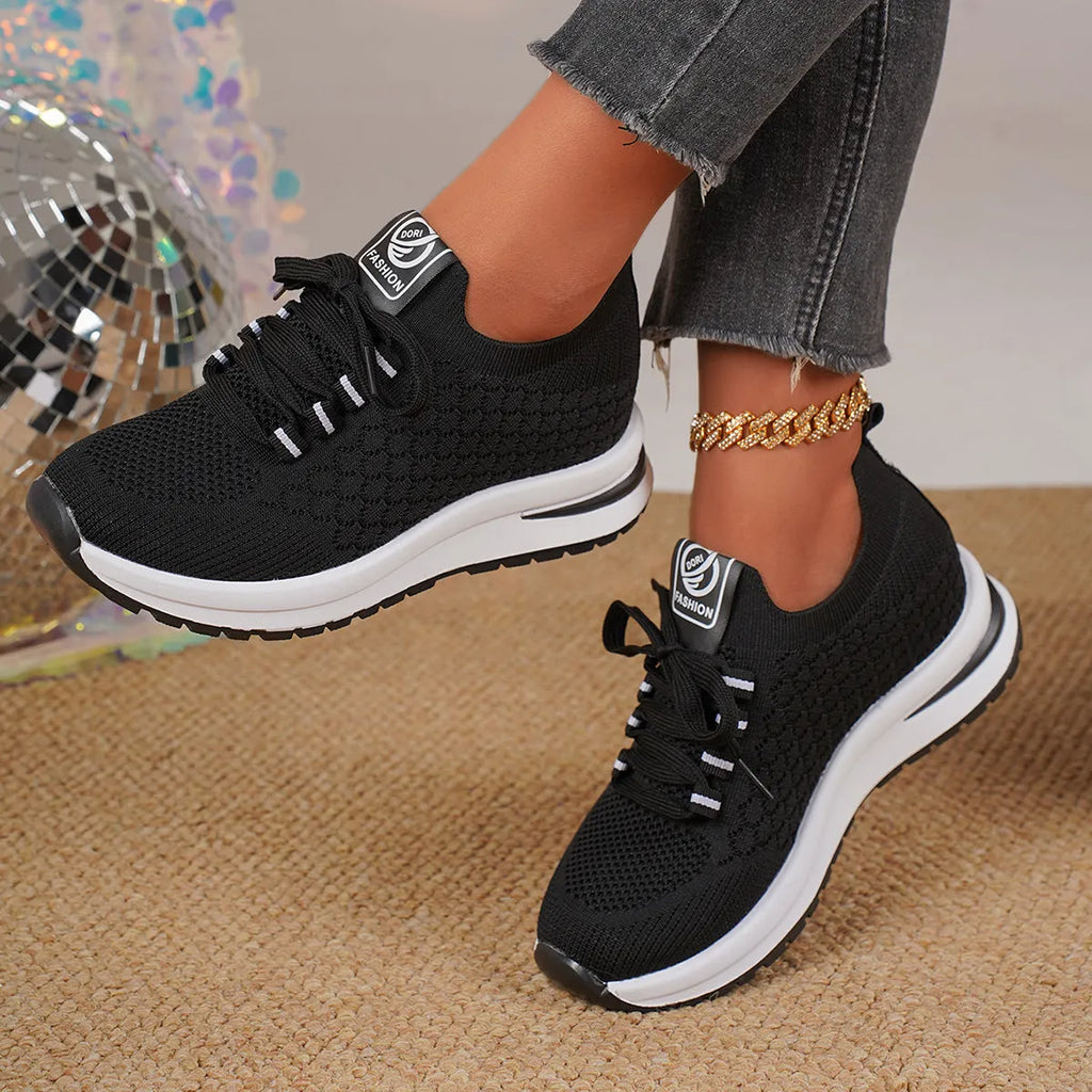 Women's black and white mesh platform sneakers with lace-up front and rubber sole