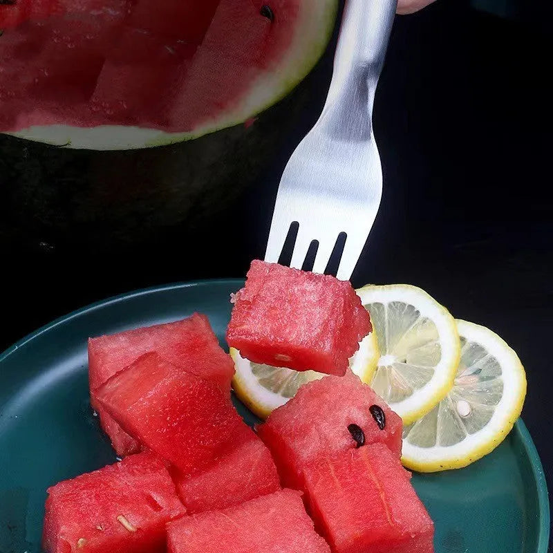 Silver stainless steel watermelon slicer with a 26cm handle and a 3.6cm wide rounded fork head.