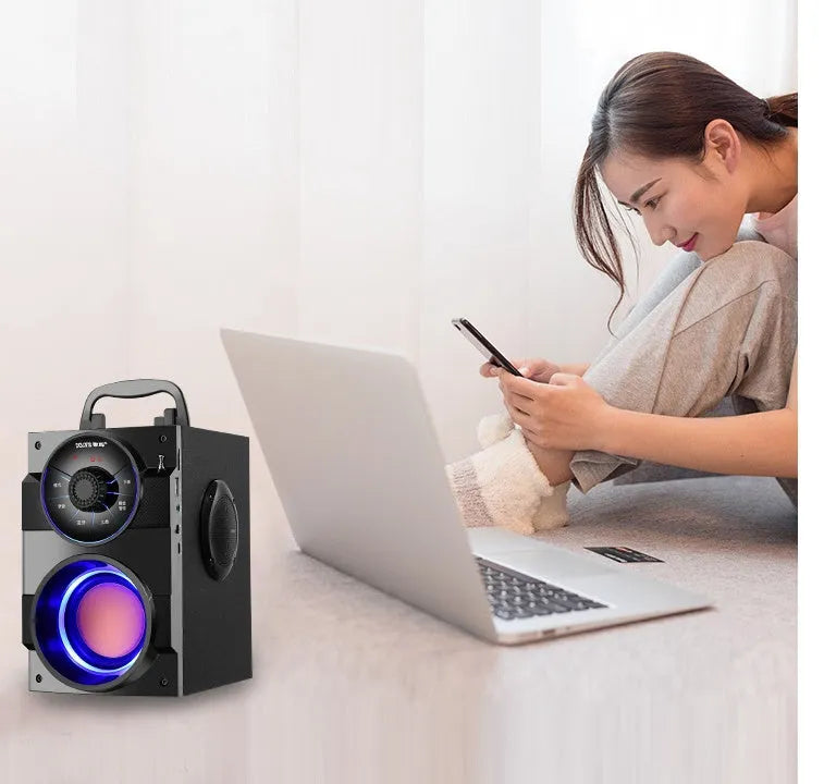 Black portable mini audio system with subwoofer and 3.5mm audio cable.