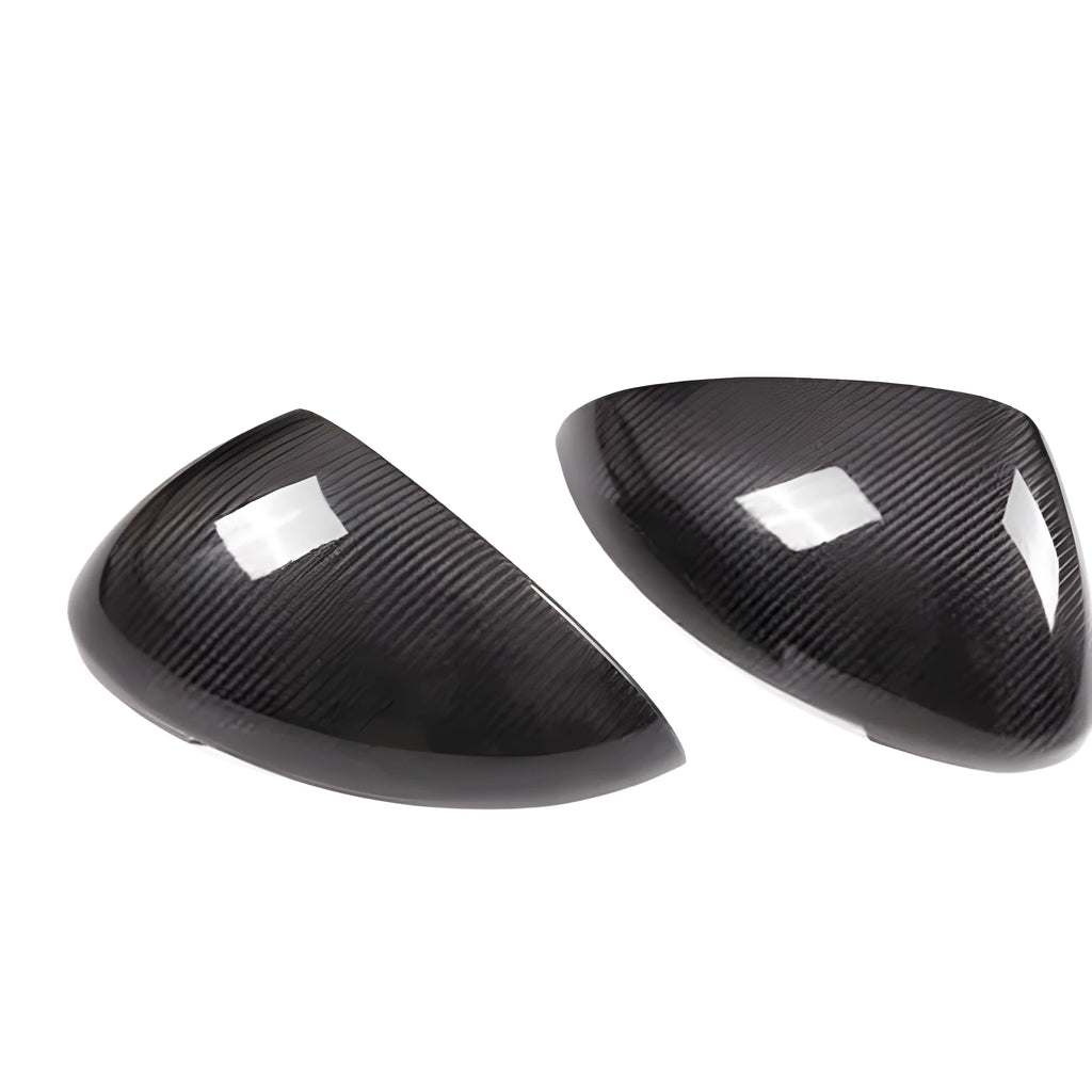 True carbon fibre exterior rearview mirror covers for a black Porsche Macan.
