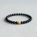 Geometric cut black obsidian stone bracelet showing 6mm, 8mm, and 10mm size beads.