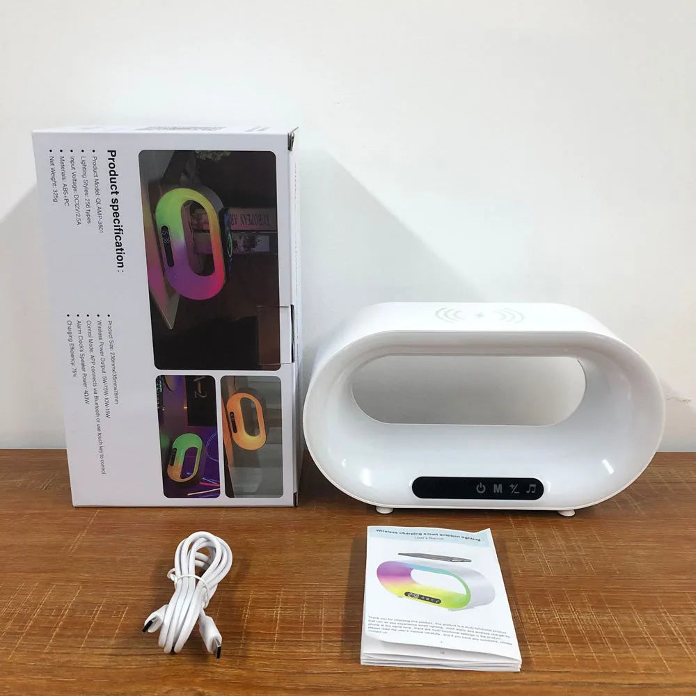 White multifunctional 3-in-1 LED night light with app control, RGB atmosphere lamp, wireless charger, and alarm clock on a desk
