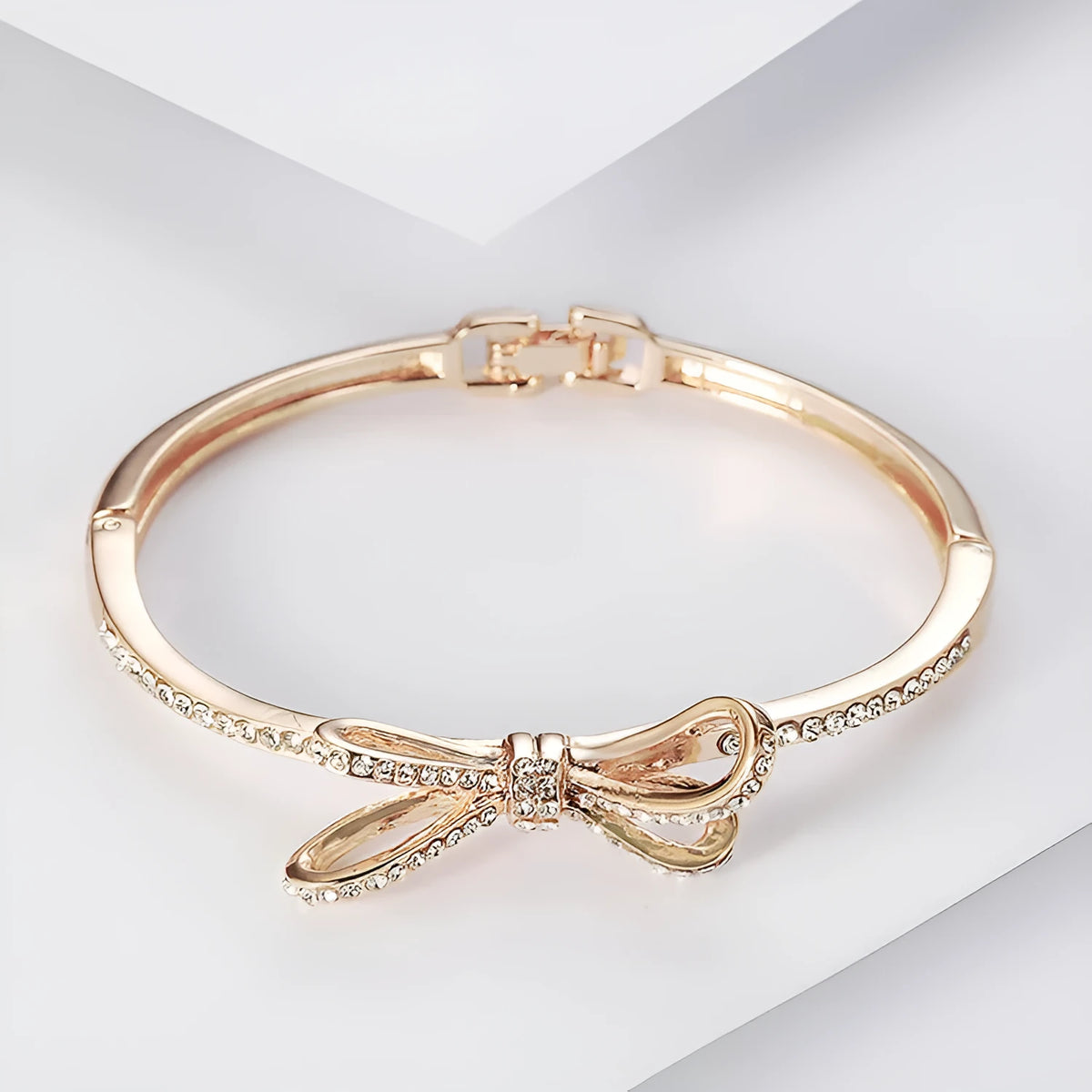Women's rose gold bow bracelet made from electroplated copper with a diamond feature