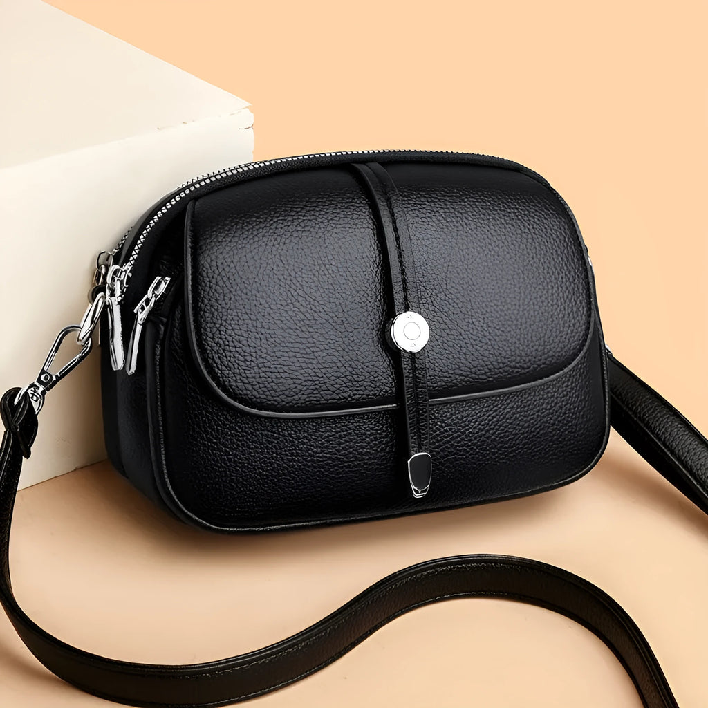 Women's crossbody shoulder bag in oval suitcase shape with soft PU construction