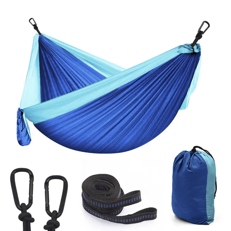 Double camping parachute hammock 300x200cm 210T nylon with tree straps and carabiners in outdoor setting
