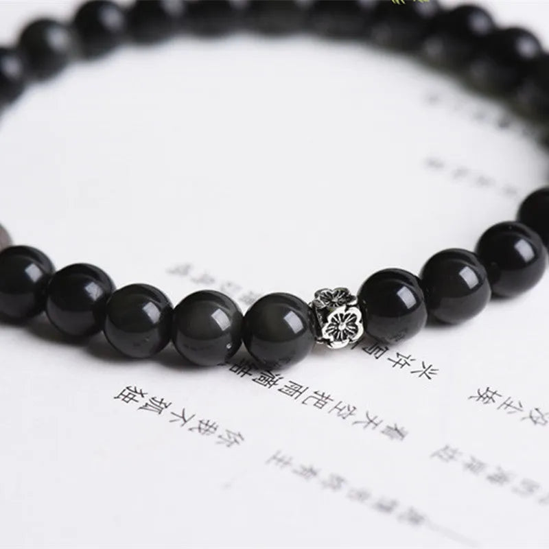 Natural obsidian bracelet with S925 silver flower accessories showing 6mm constellation design and dragon phoenix decorations