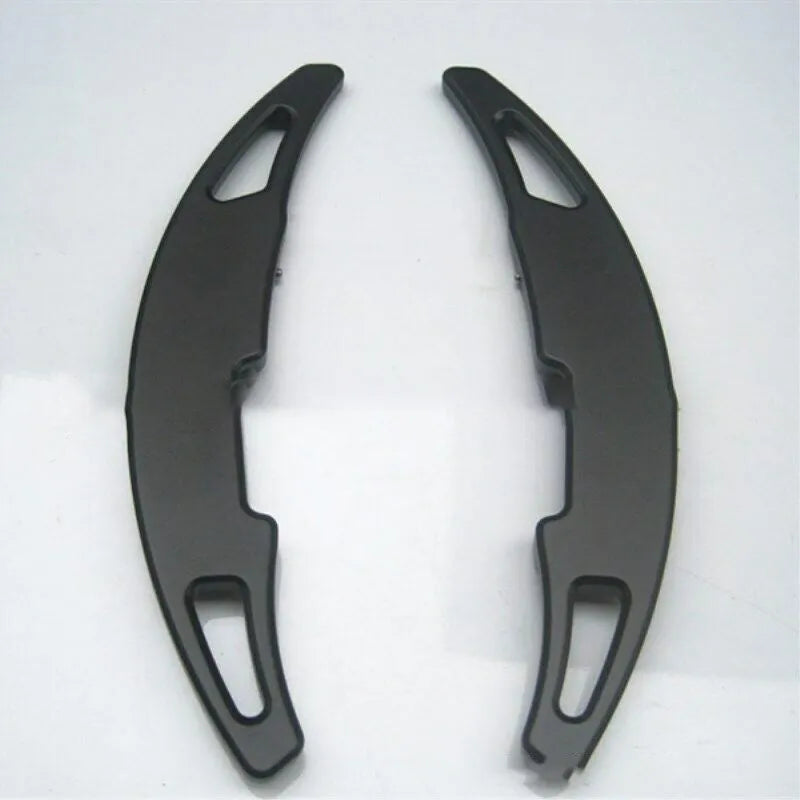 Pair of BMW M paddle shift extenders in black with 3M adhesive and screws
