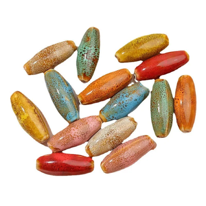 Ceramic bullet beads for jewellery making in various glaze colours including pink, yellow, blue, and red